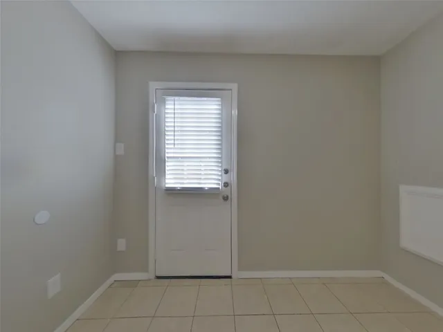 a kitchen with granite countertop a sink stove and cabinets