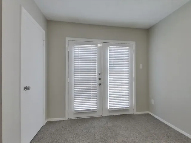a view of an empty room and a window