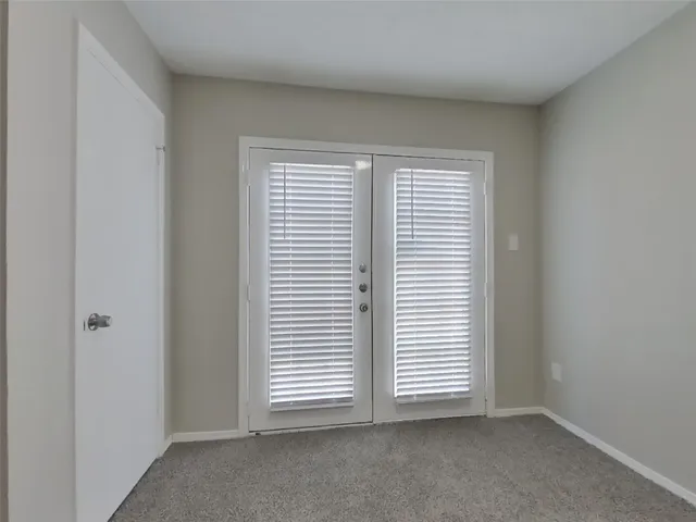 a view of an empty room and a window