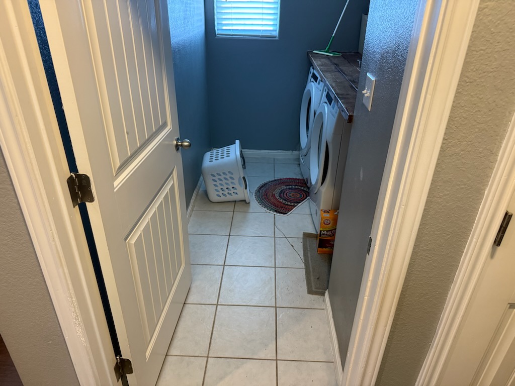 351 Wincliff Drive Buda, TX 78610 - Photo 16 of 25 Laundry room featuring light tile patterned flooring and baseboards