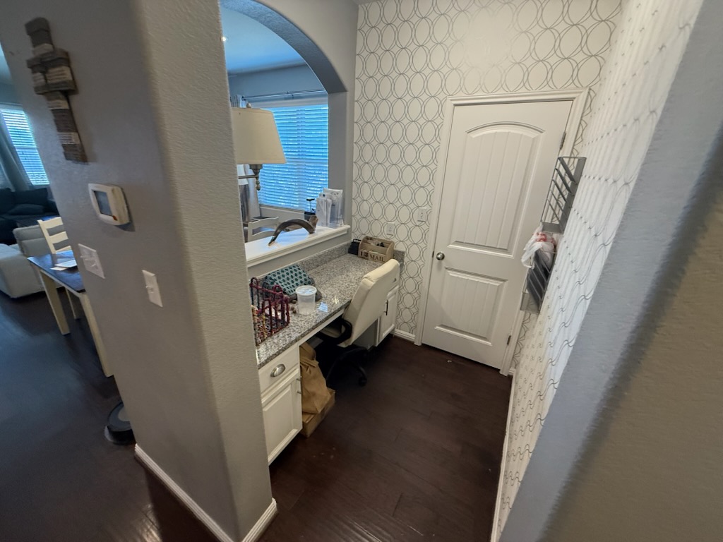 351 Wincliff Drive Buda, TX 78610 - Photo 21 of 25 Hall with dark wood finished floors, arched walkways, and a desk