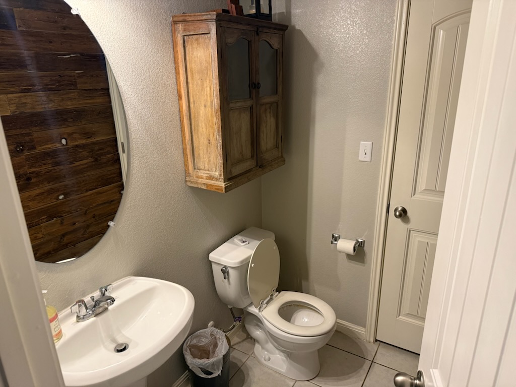 351 Wincliff Drive Buda, TX 78610 - Photo 9 of 25 Bathroom featuring a textured wall and light tile patterned flooring
