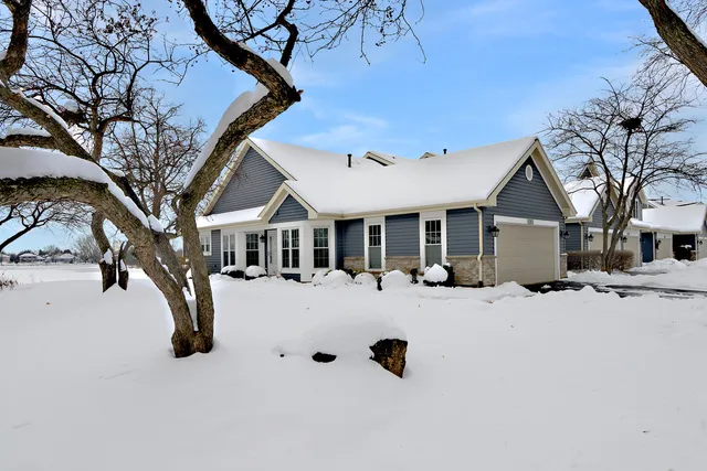 a view of a house with a yard covered in snow