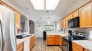 a kitchen with stainless steel appliances granite countertop a stove and a sink