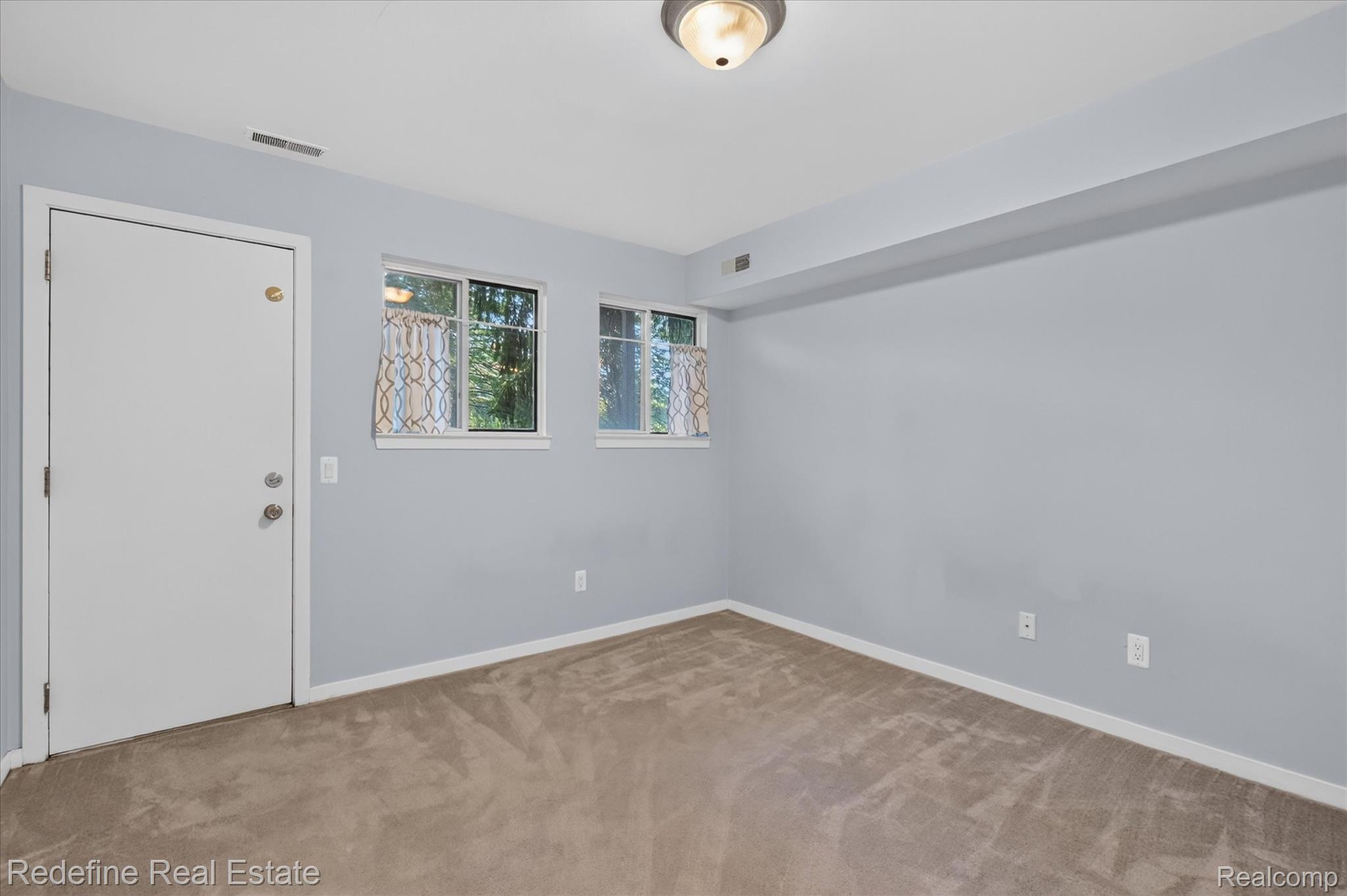 27971 Rollcrest Road, Unit 9 Farmington, MI 48334 - Photo 18 of 25 Wall-to-wall carpeting with light-toned walls and trim