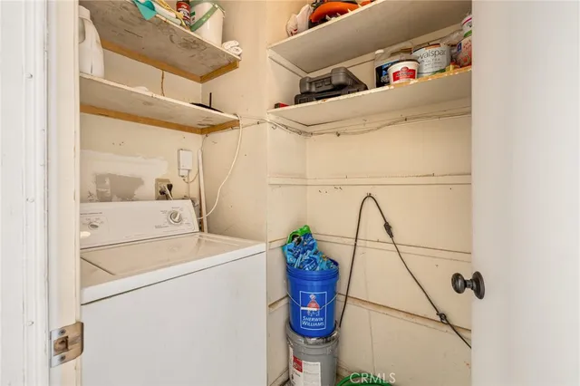 a dining room with furniture and a floor to ceiling window next to a yard