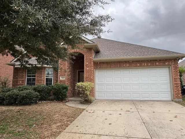 a front view of a house with garage