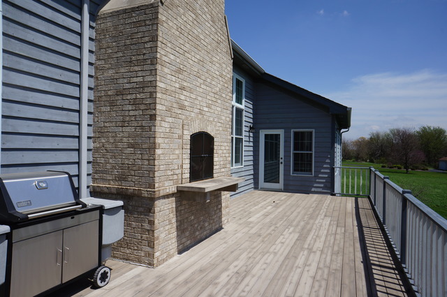 43W145 Campton Hills Road Elburn, IL 60119 - Photo 21 of 23 a backyard of a house with wooden floor outdoor seating and yard in the back