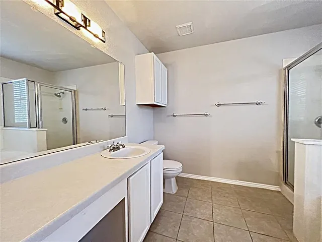 a bathroom with a sink a toilet and a shower