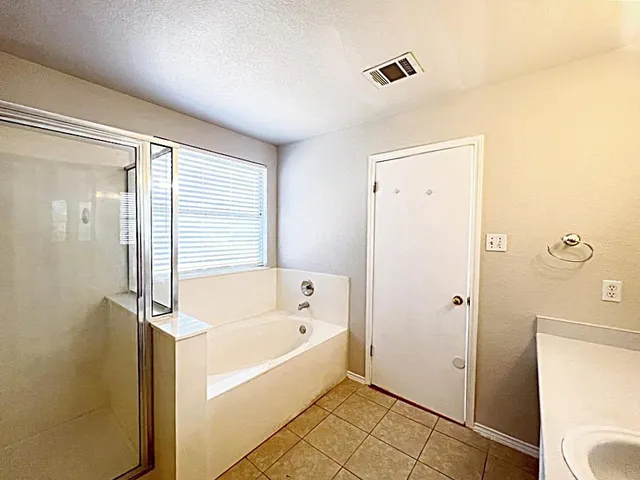 a bathroom with a bathtub and shower