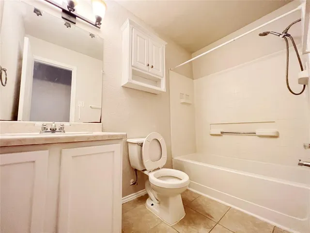 a bathroom with a toilet sink and shower