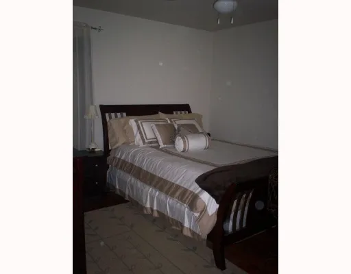 a bed sitting in a bedroom next to a wall