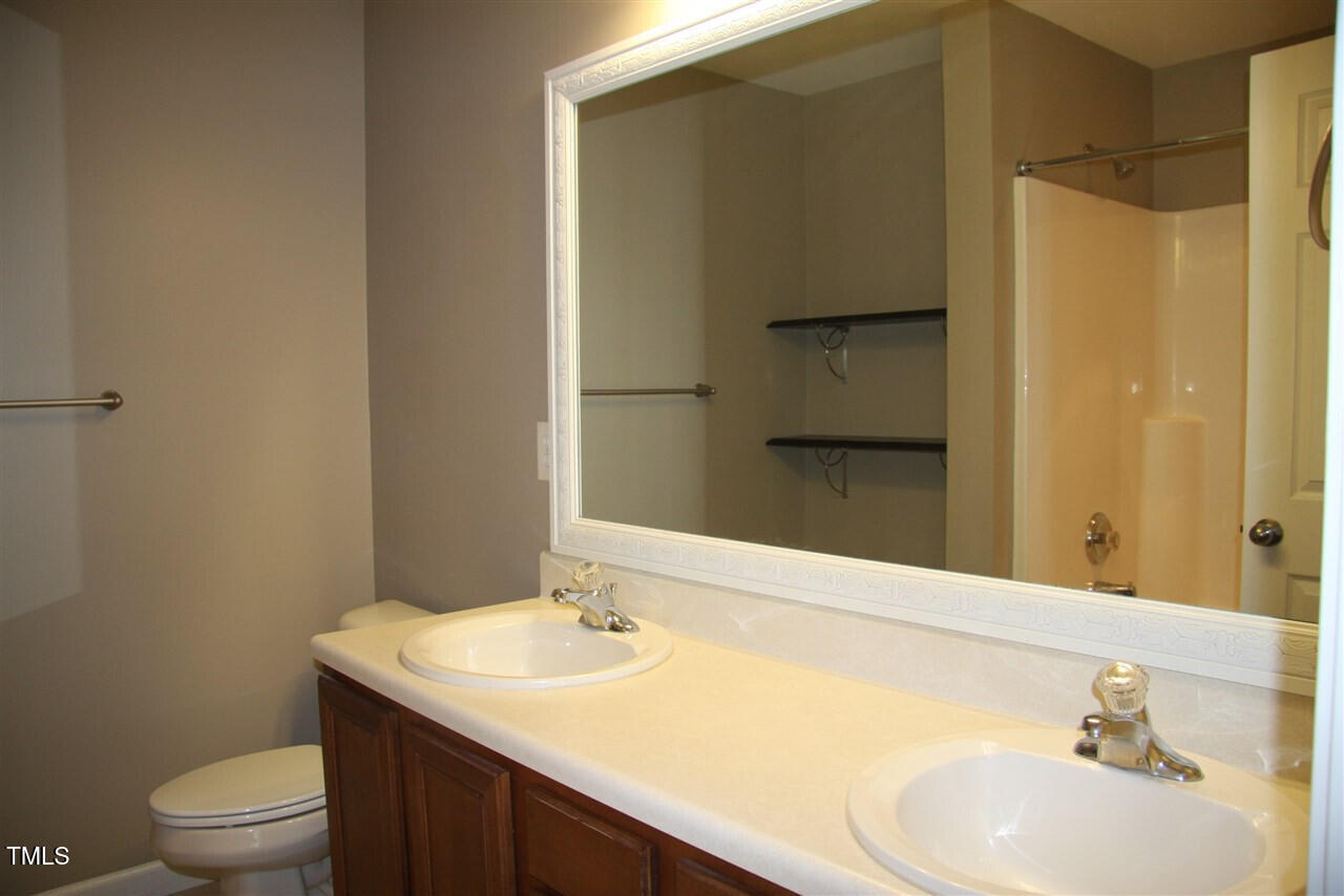 1045 Summerhouse Road Cary, NC 27519 - Photo 12 of 20 a bathroom with a sink toilet and shower