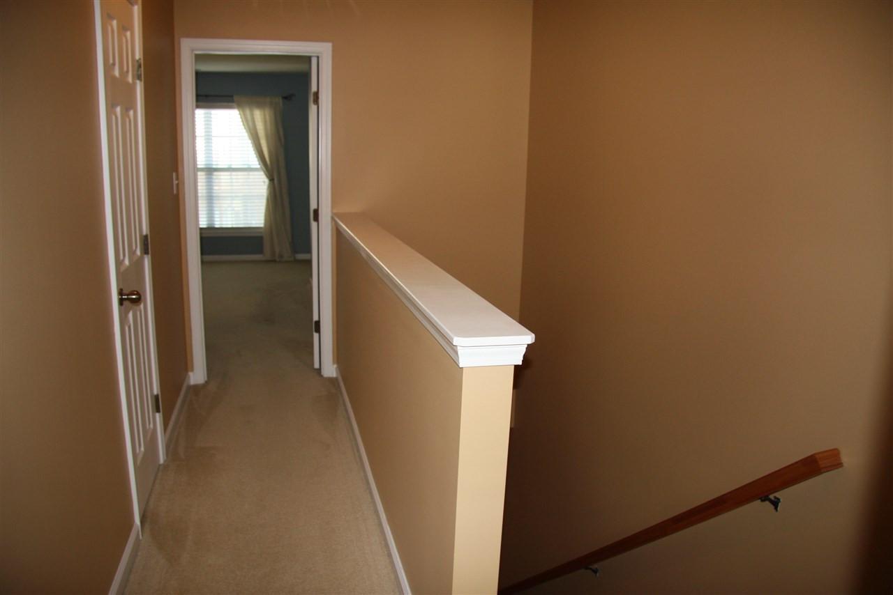 1045 Summerhouse Road Cary, NC 27519 - Photo 9 of 20 a view of a hallway with wooden floor