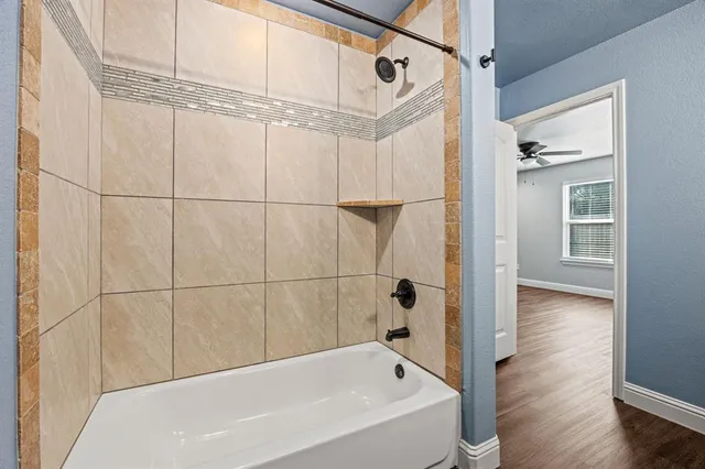 a bathroom with a bathtub and a shower