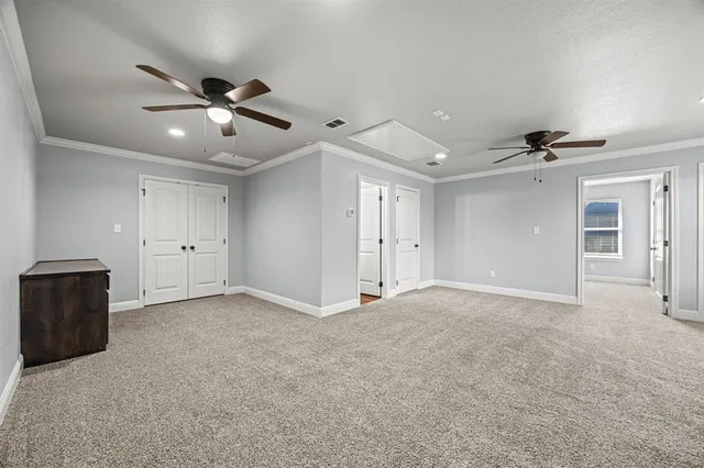 a view of an empty room with a ceiling fan