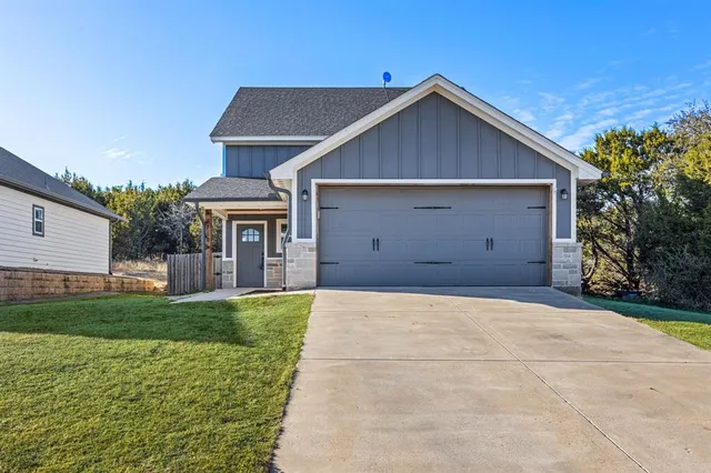 a view of garage yard and front view of house