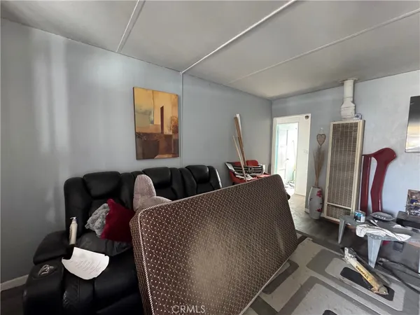 a living room with furniture chess board and a flat screen tv