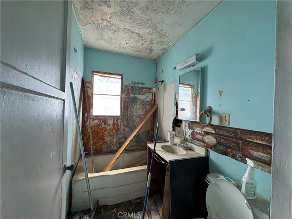 a bathroom with a sink a mirror and a toilet