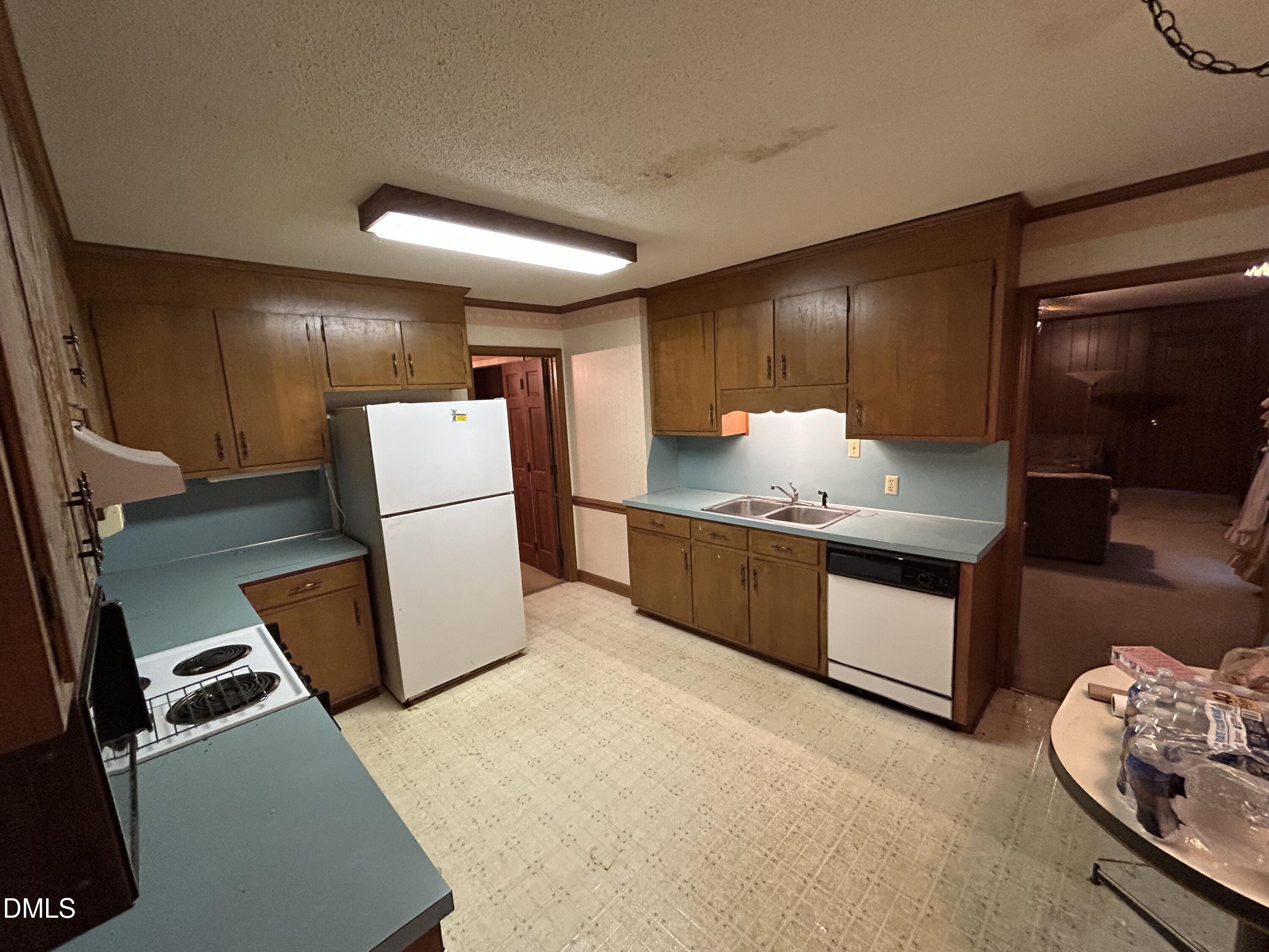 2912 Oxford Road Henderson, NC 27536 - Photo 13 of 25 a kitchen with a refrigerator and a stove