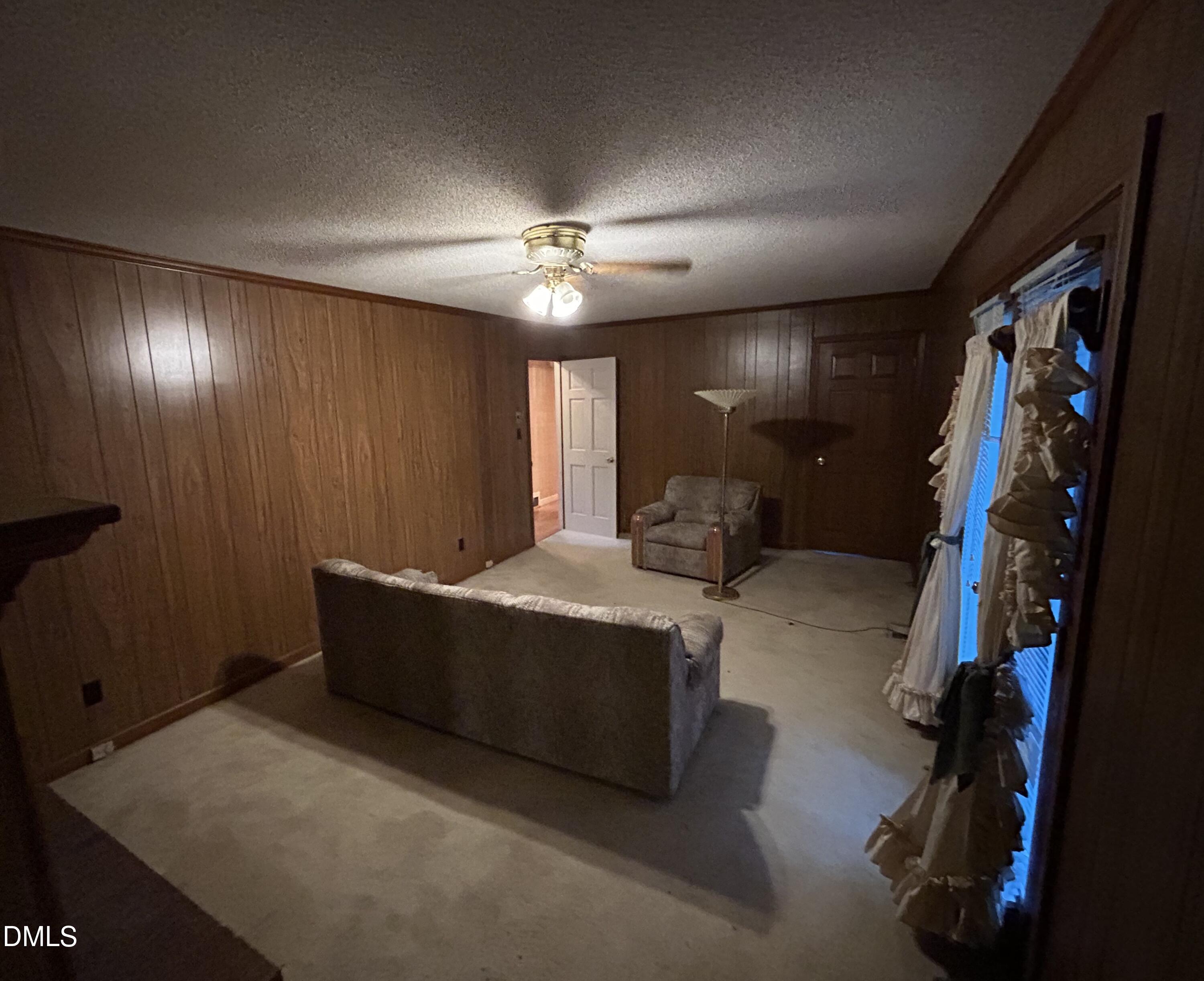 2912 Oxford Road Henderson, NC 27536 - Photo 15 of 25 a living room with furniture and a flat screen tv
