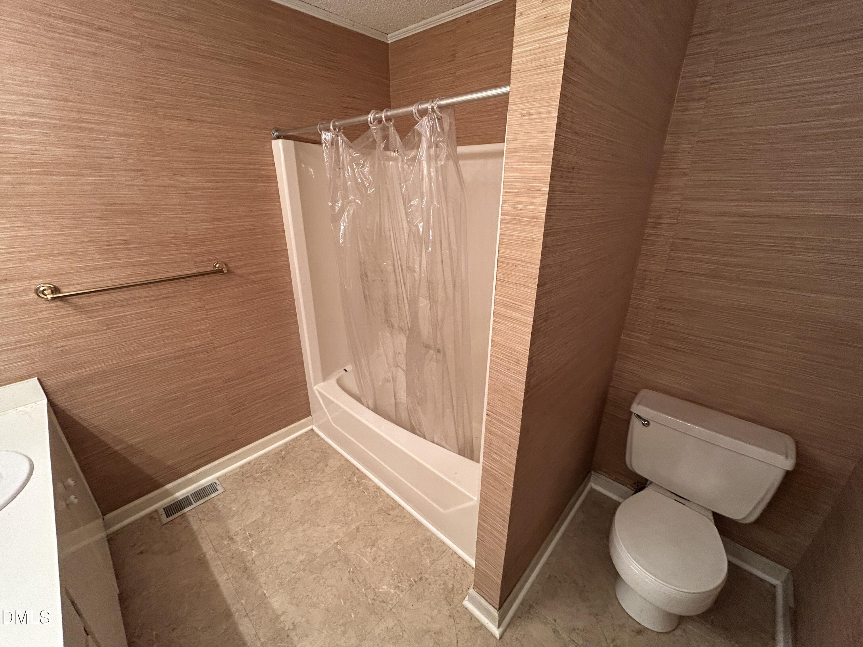 2912 Oxford Road Henderson, NC 27536 - Photo 16 of 25 a bathroom with a toilet and a shower