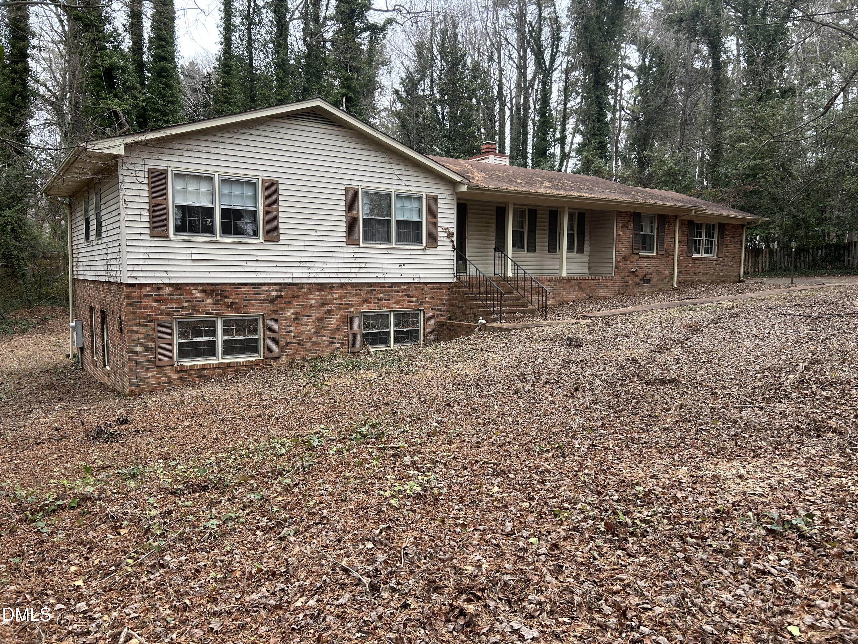 2912 Oxford Road Henderson, NC 27536 - Photo 2 of 25 a front view of a house with a garden