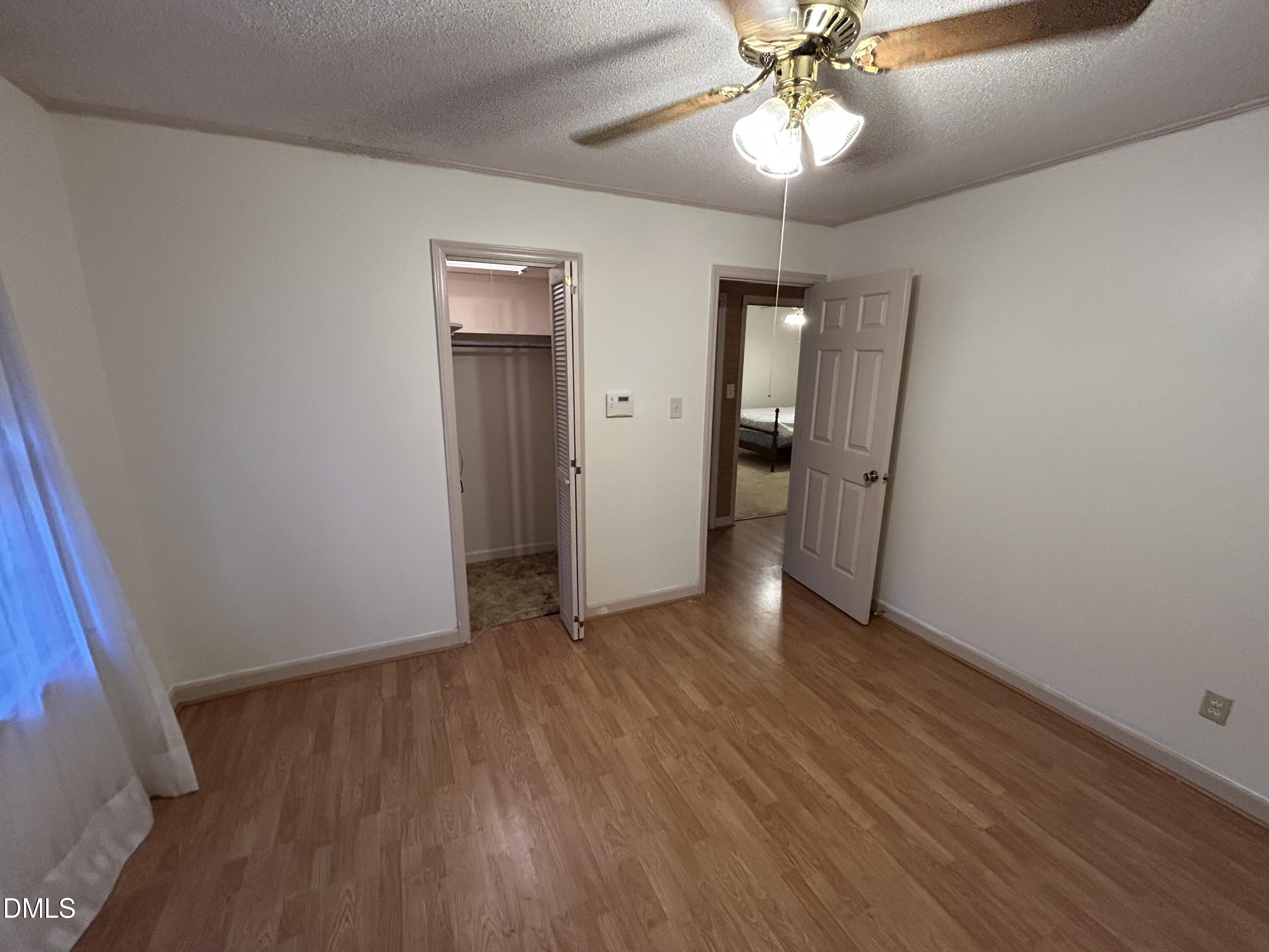 2912 Oxford Road Henderson, NC 27536 - Photo 23 of 25 wooden floor in an empty room with a window