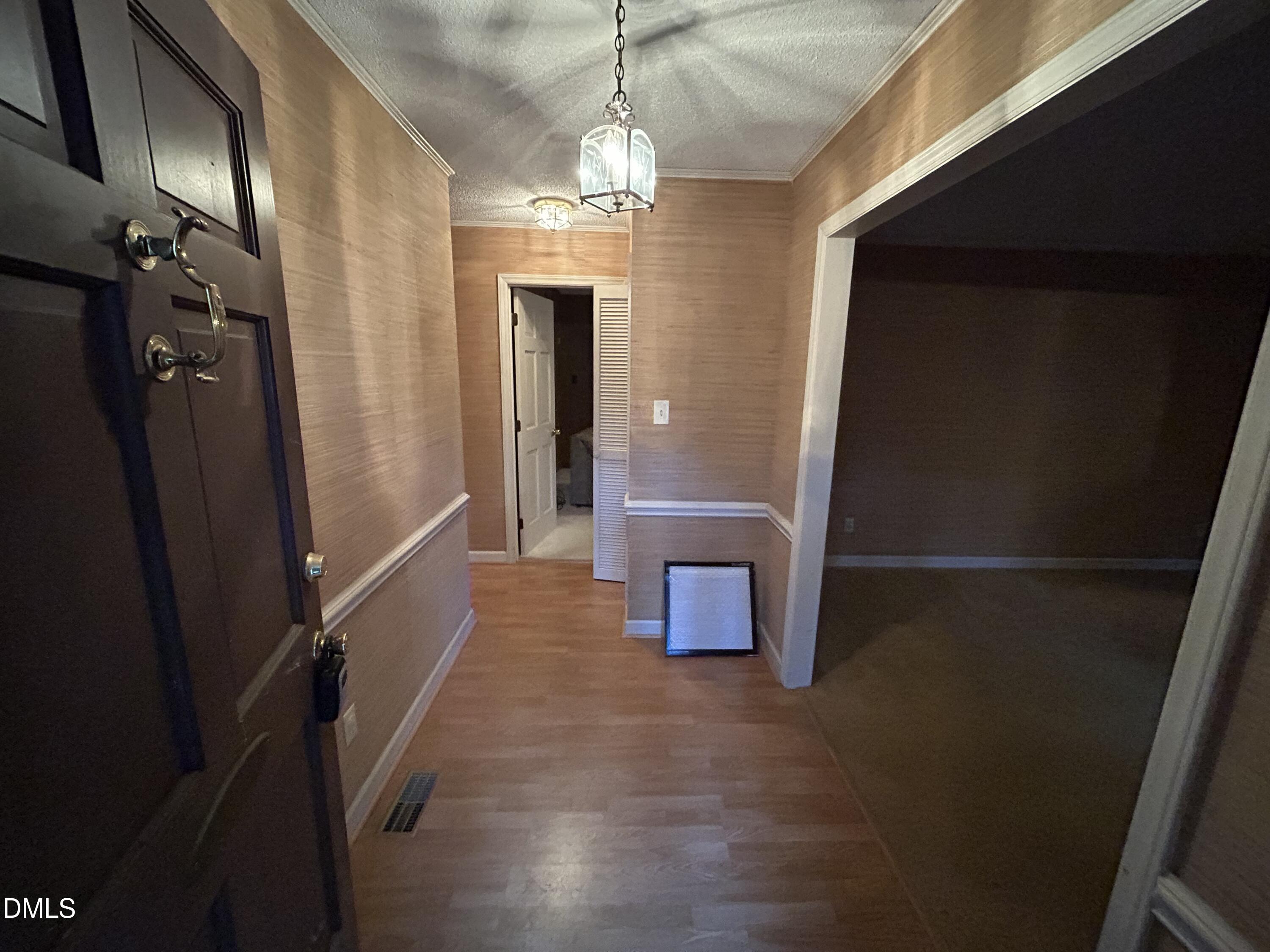 2912 Oxford Road Henderson, NC 27536 - Photo 7 of 25 a view of a hallway with wooden floor and staircase