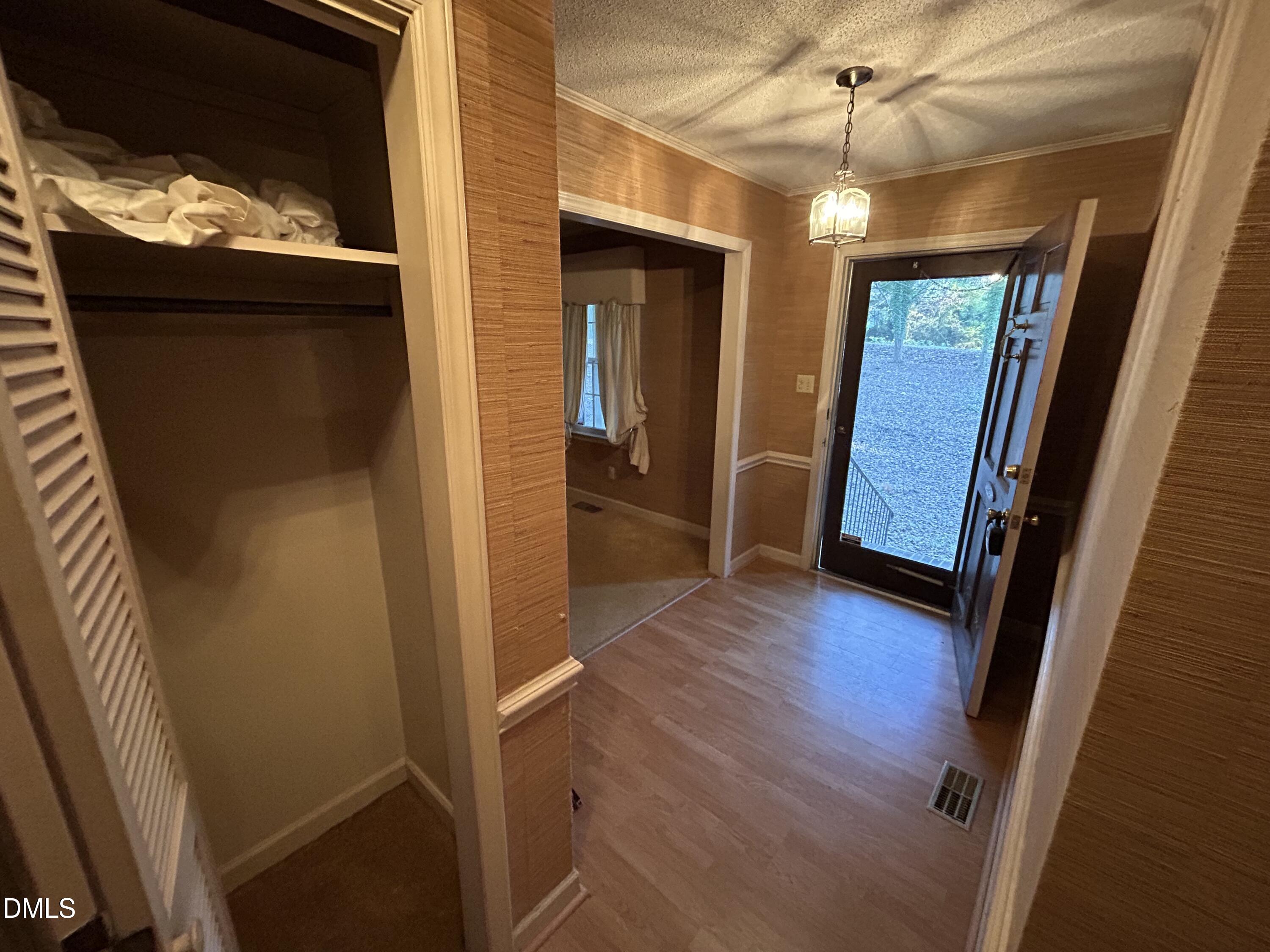 2912 Oxford Road Henderson, NC 27536 - Photo 8 of 25 a view of a hallway with wooden floor and stairs