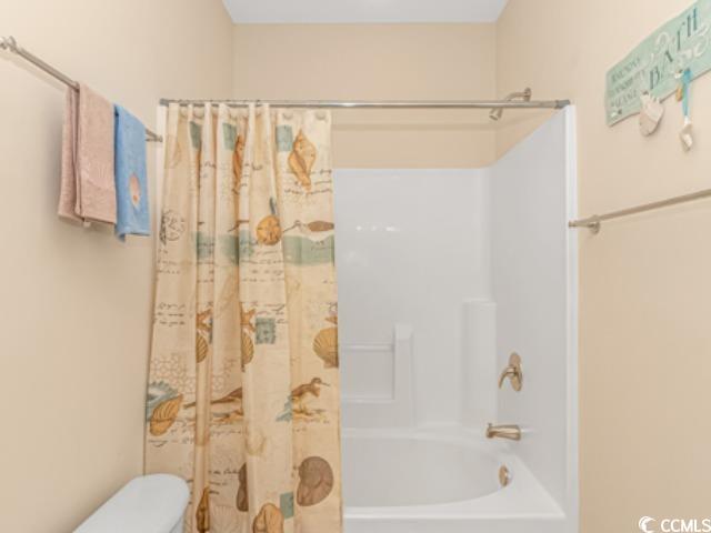 5804 Longwood Drive, Unit 203 Murrells Inlet, SC 29576 - Photo 18 of 31 Bathroom featuring toilet and shower / bath combination with curtain