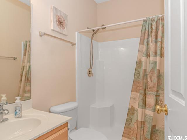 5804 Longwood Drive, Unit 203 Murrells Inlet, SC 29576 - Photo 21 of 31 Bathroom with vanity, toilet, and curtained shower