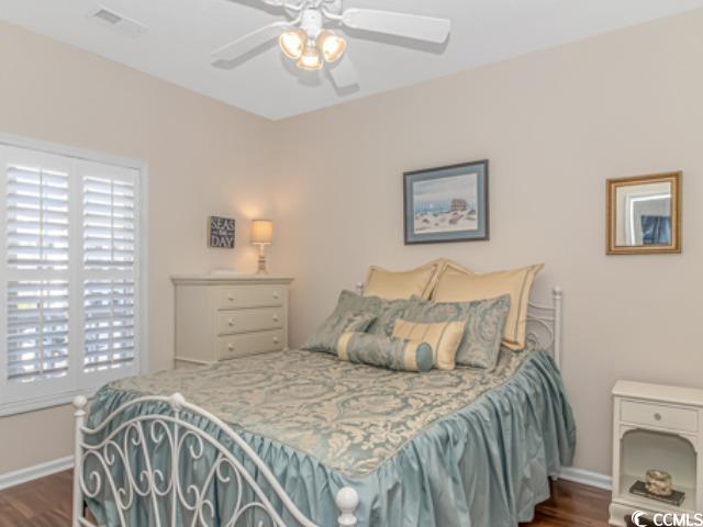 5804 Longwood Drive, Unit 203 Murrells Inlet, SC 29576 - Photo 22 of 31 Bedroom featuring dark wood-type flooring, ceiling fan, and multiple windows