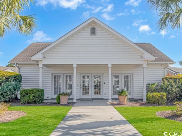 5804 Longwood Drive, Unit 203 Murrells Inlet, SC 29576 - Photo 29 of 31 View of front facade featuring french doors and a front lawn