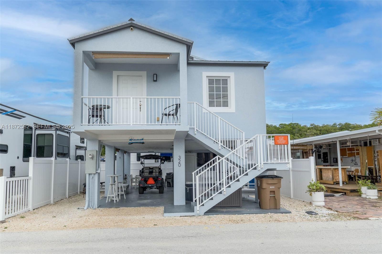 325 Calusa Street, Unit 320 Key Largo, FL 33037 - Photo 1 of 52 a view of a house with a small yard and potted plants