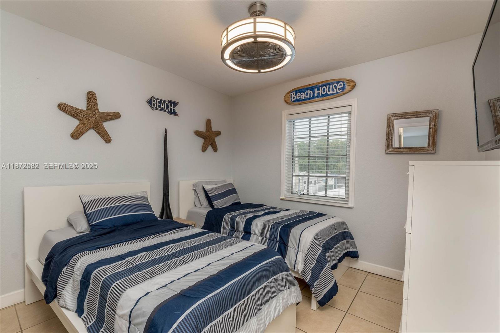 325 Calusa Street, Unit 320 Key Largo, FL 33037 - Photo 24 of 52 a bedroom with two beds and a window
