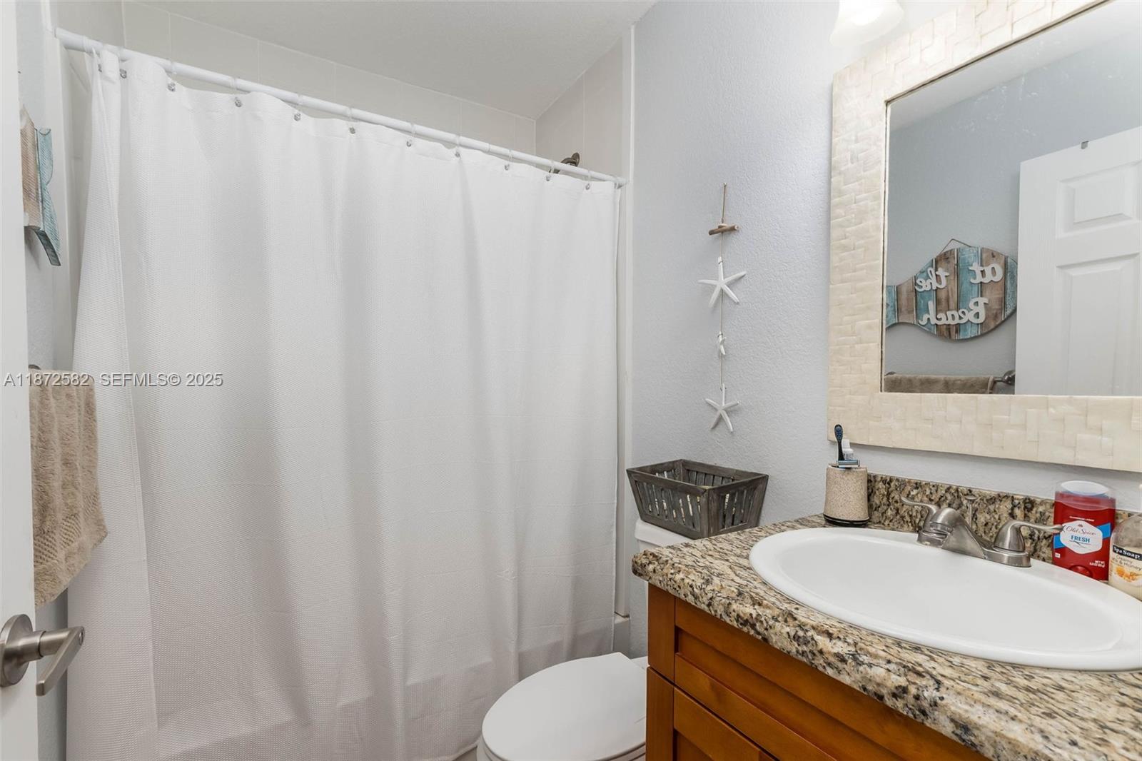 325 Calusa Street, Unit 320 Key Largo, FL 33037 - Photo 25 of 52 a bathroom with a granite countertop sink and a mirror