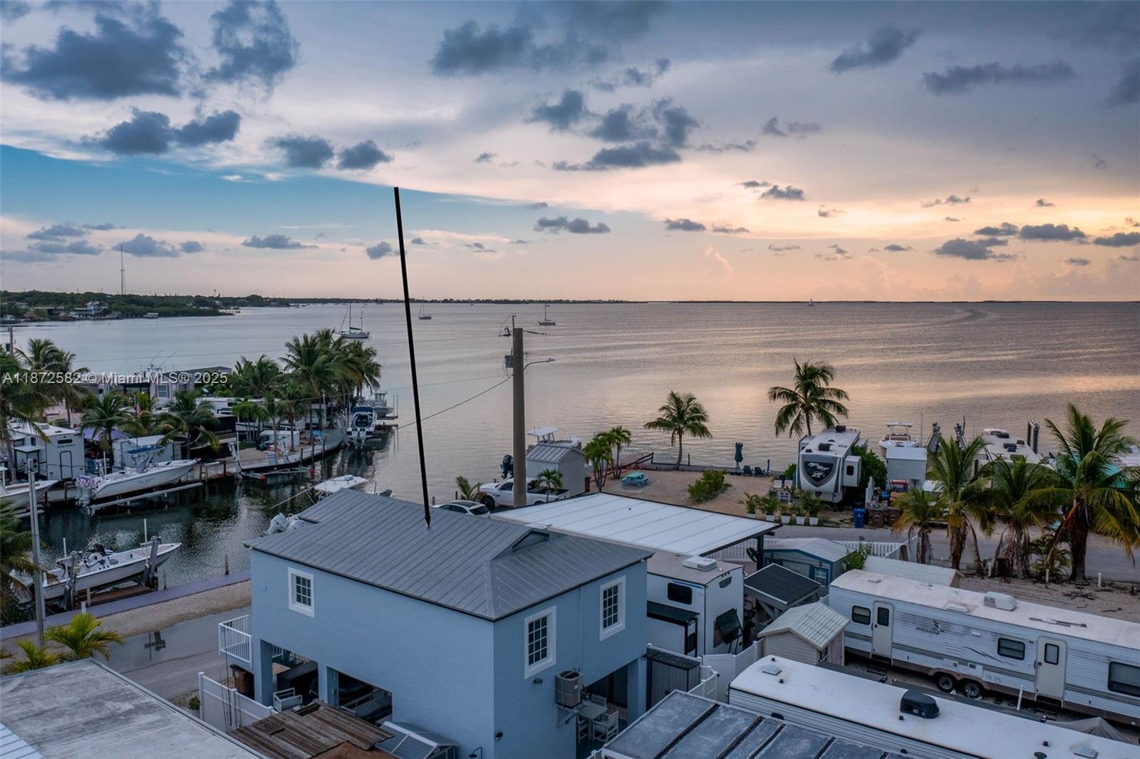 325 Calusa Street, Unit 320 Key Largo, FL 33037 - Photo 29 of 52 a view of a terrace with furniture and stove