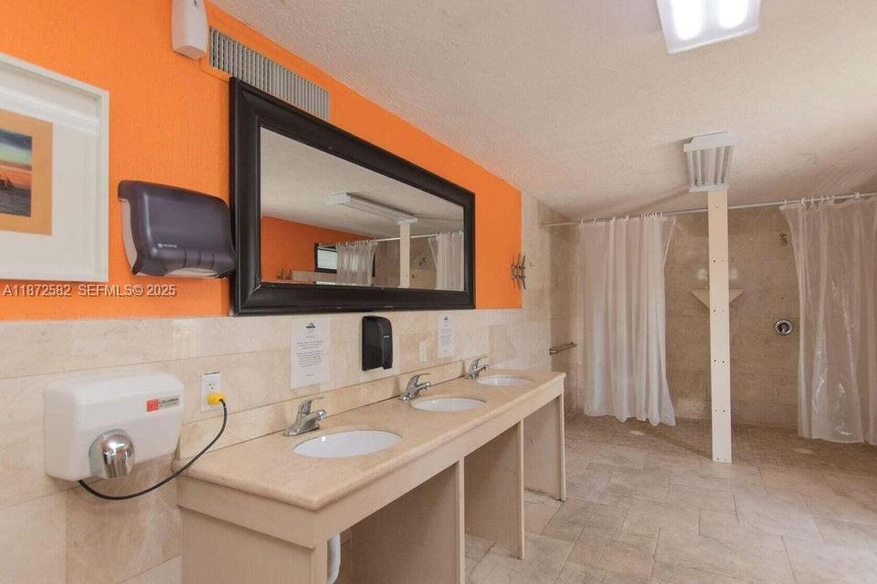 325 Calusa Street, Unit 320 Key Largo, FL 33037 - Photo 47 of 52 a bathroom with a sink and a mirror