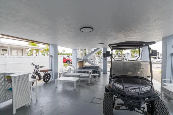 a living room with furniture a chandelier and a window