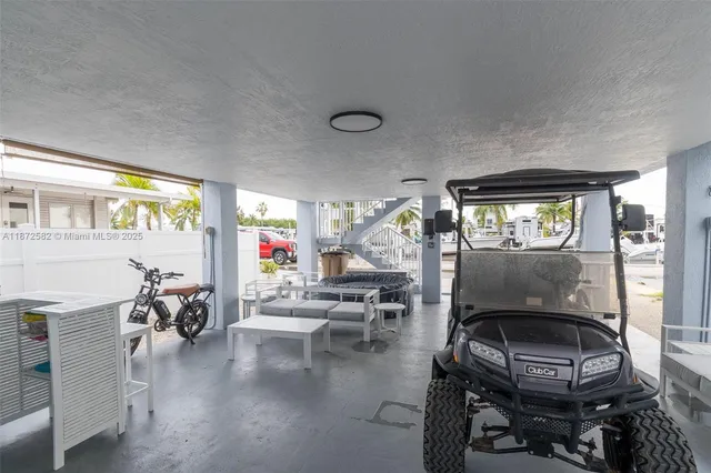 a living room with furniture a chandelier and a window