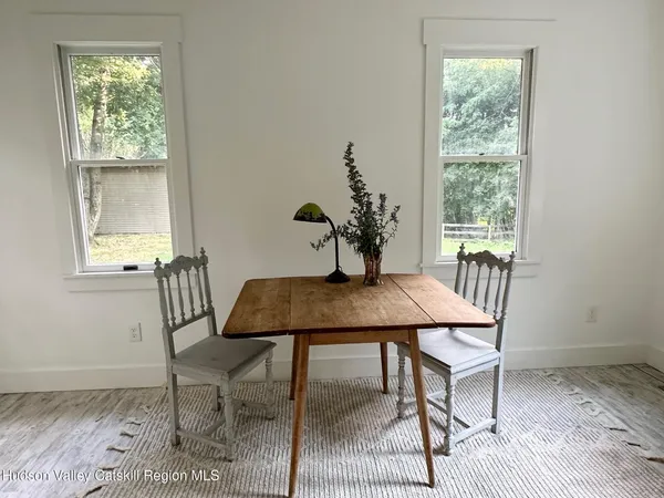 a view of a workspace with furniture and wooden floor