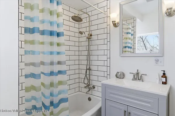 a view of a house with brick walls and a yard with plants