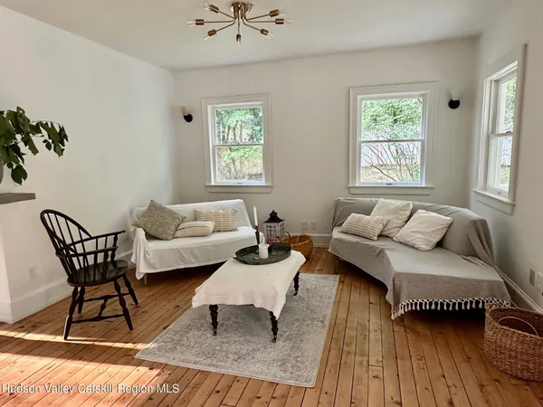 a living room with furniture rug and window