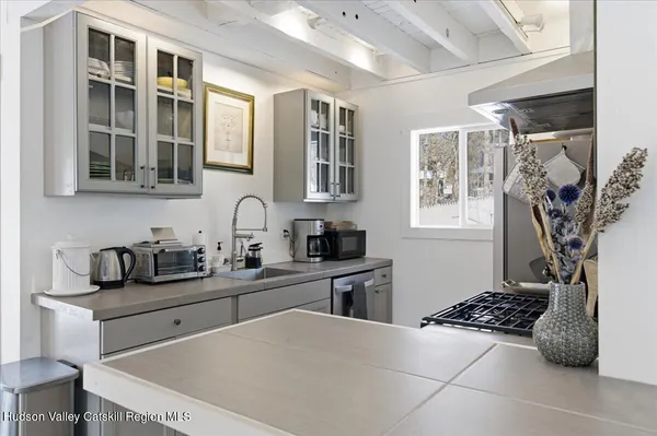 a kitchen with stainless steel appliances granite countertop a sink and a window