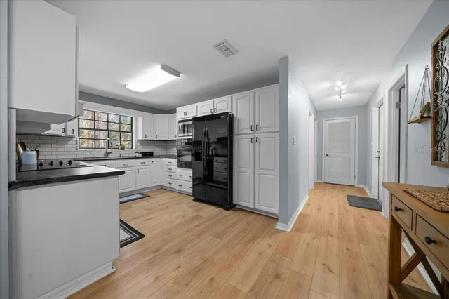a kitchen with stainless steel appliances a refrigerator and a stove top oven