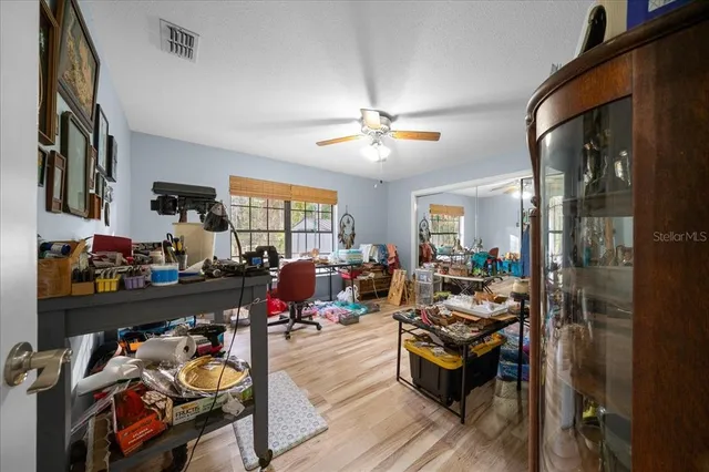 a view of a hallway with a dining table & chairs
