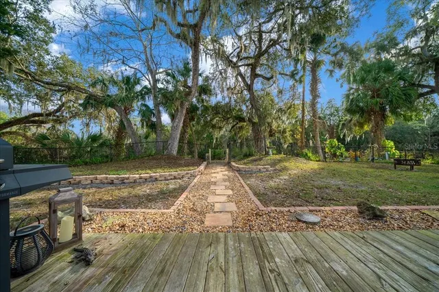 a view of balcony with wooden floor and fence