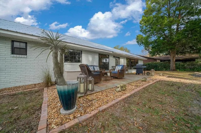 a view of balcony with wooden floor and outdoor seating