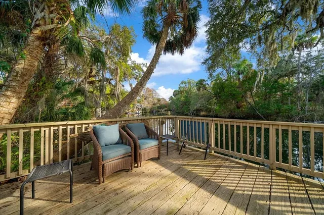 a view of balcony with wooden floor and lake view